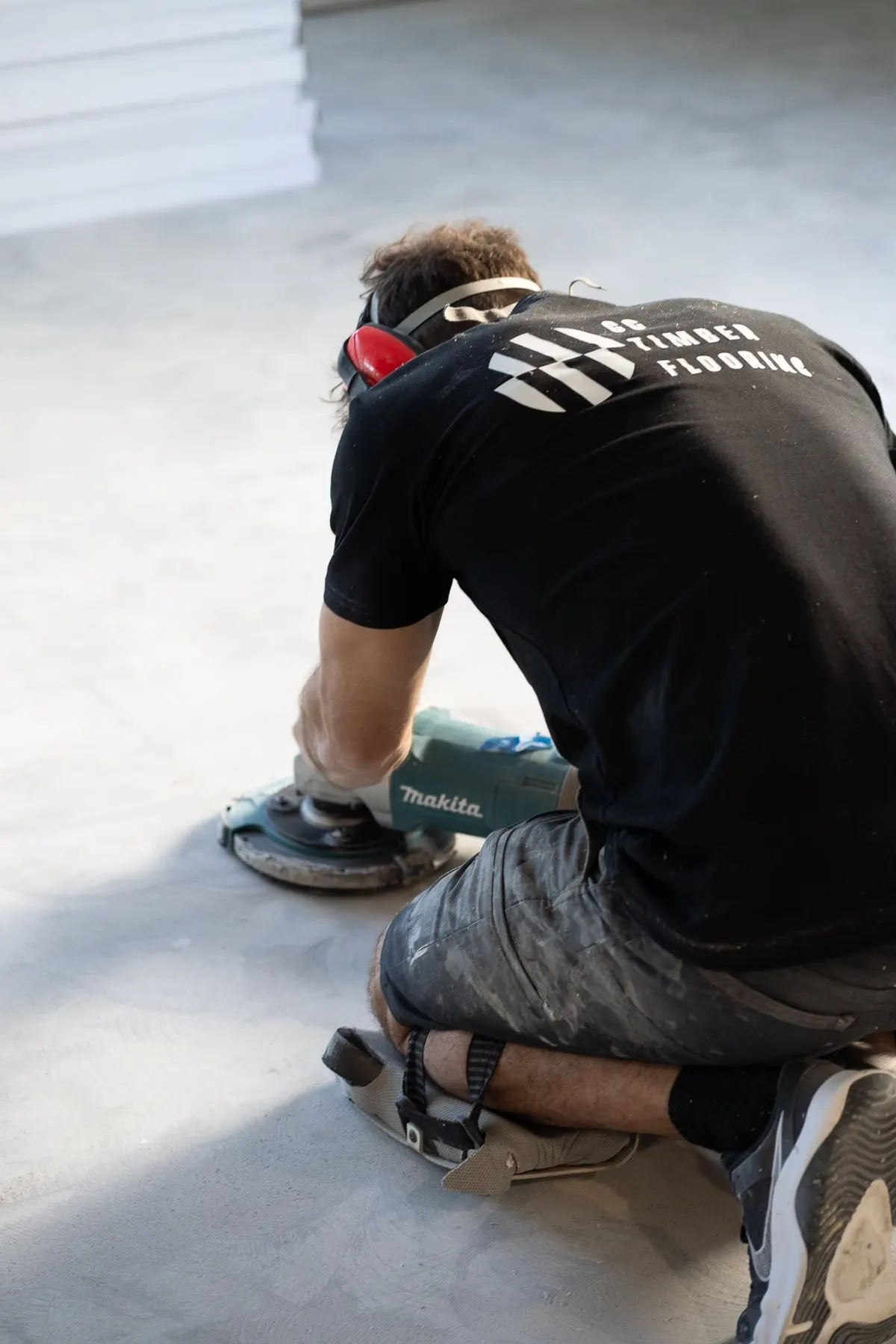 Fabrizio grinding a concrete slab as part of floor preparation