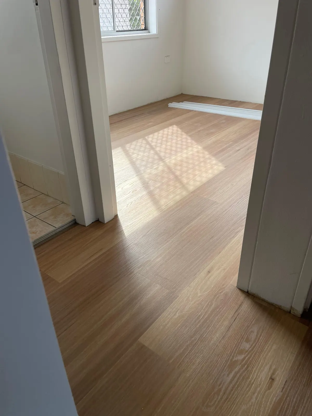 Laminate flooring seen through a bedroom doorway
