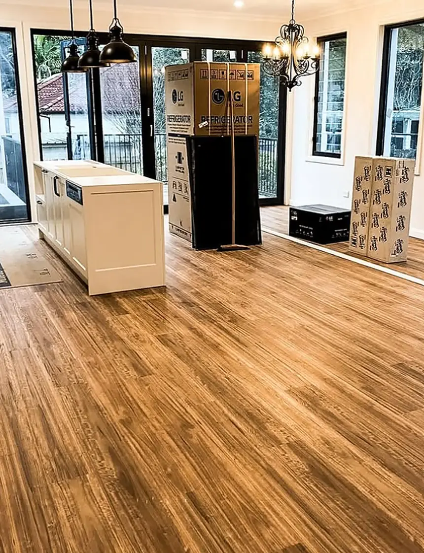 Finished wood-look floor running through an open-plan kitchen and dining area