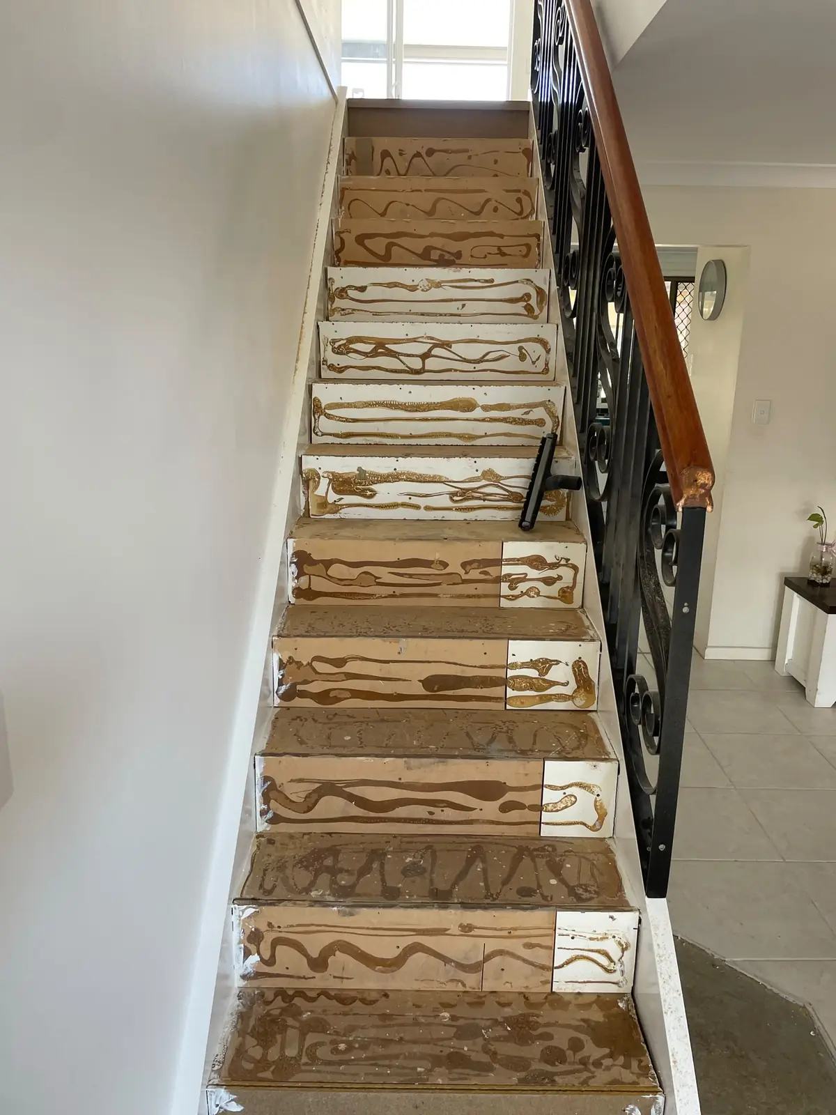 Adhesive applied to prepared stair treads and risers ready for timber