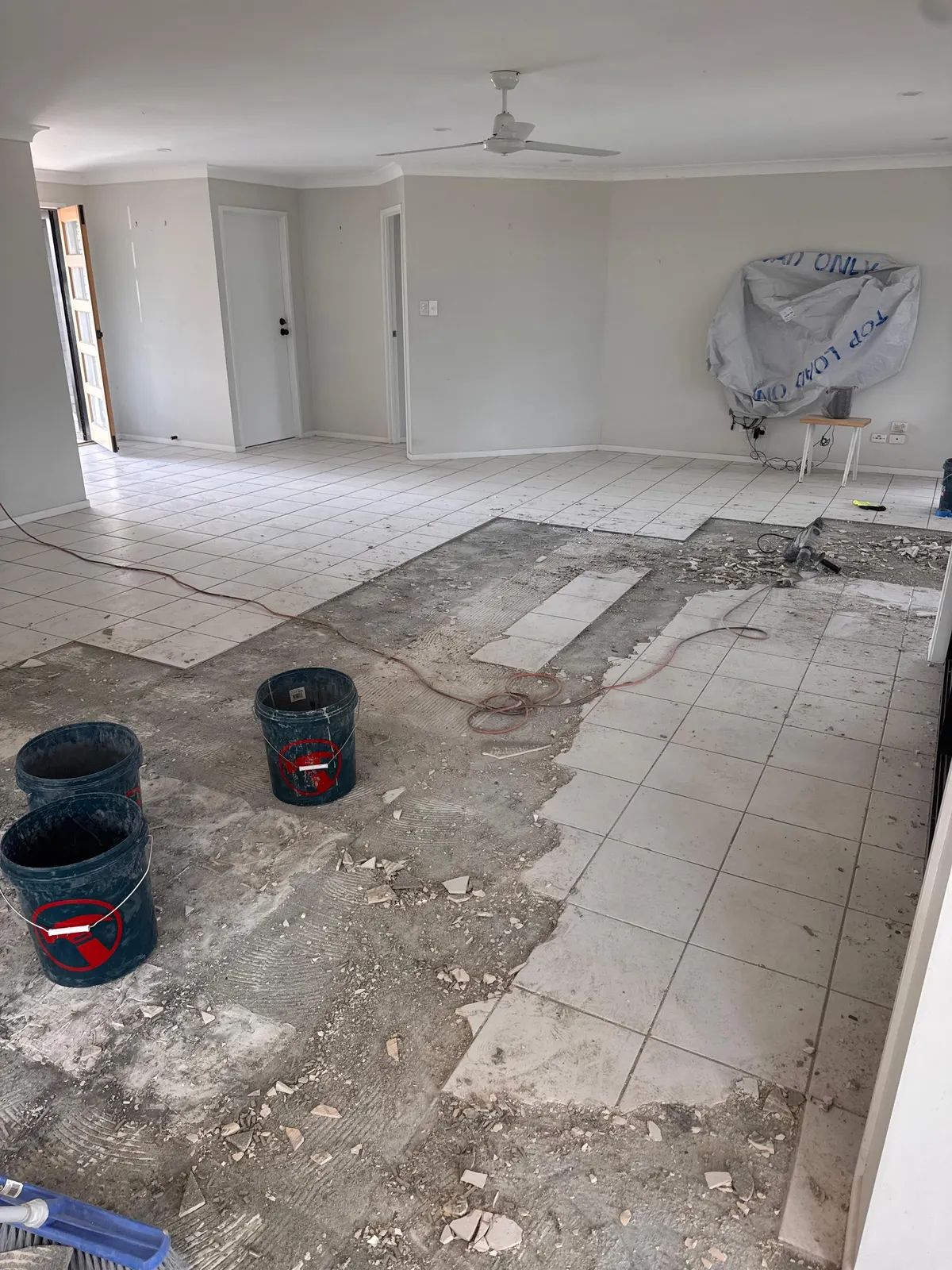 Old floor tiles being removed before the new floor goes down