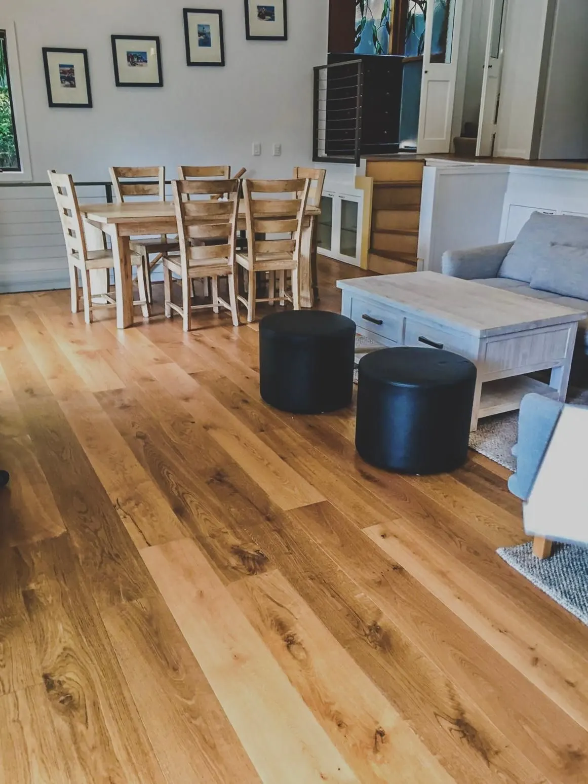 Timber floorboards running through a furnished dining and living area
